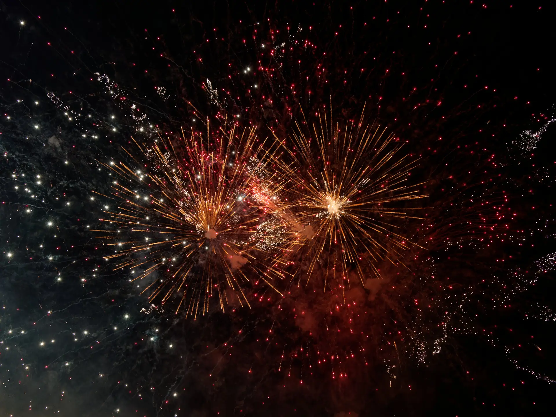 Red and Gold Fireworks in Night Sky 4K Desktop Wallpaper
