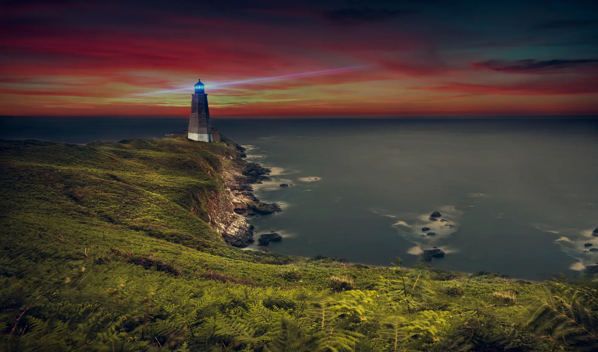 Coastal Lighthouse at Red Sunset Landscape