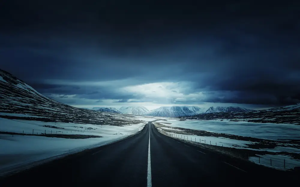 Lonely Dark Highway in Snowy Landscape